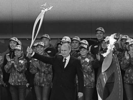 Vladimir Putin with the Olympic Torch at a ceremony in Moscow October 5. (Photo Courtesy of EPA)