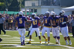 From left: Marcus Arkarakas (#5), Anthony Powless (#87), Anthony Pizzuti (#8), Chris Reddy (#66), and Michael Malanda (#57), celebrate a Laurier touchdown reception by Pizzuti. The touchdown, thrown by James Fracas, gave the Golden Hawks a 24-0 lead early in the second quarter. Photo by Jacob Dearlove