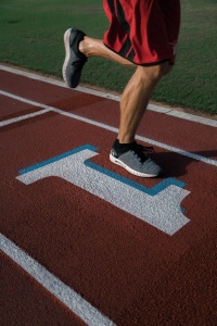 A runner's feet on a track.