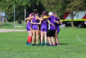Cross country team in a huddle