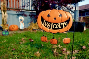 A jack-o-lantern decoration that reads, "Welcome."
