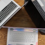 Three laptops organized in a triangle formation