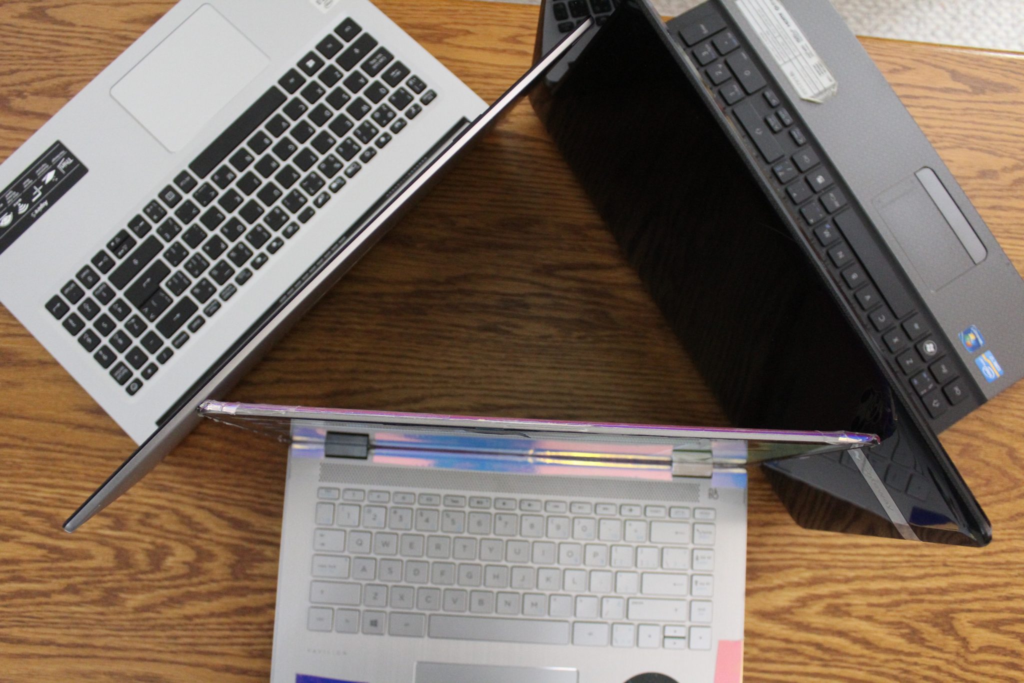 Three laptops organized in a triangle formation
