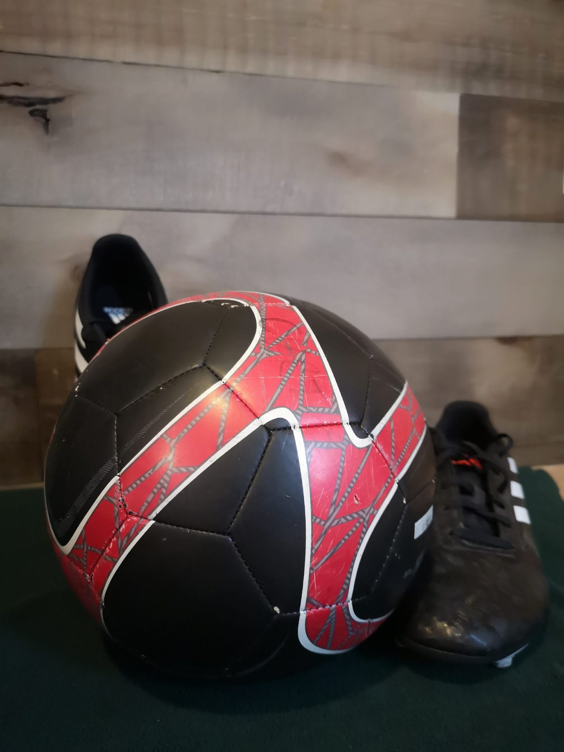 A soccer ball and cleats